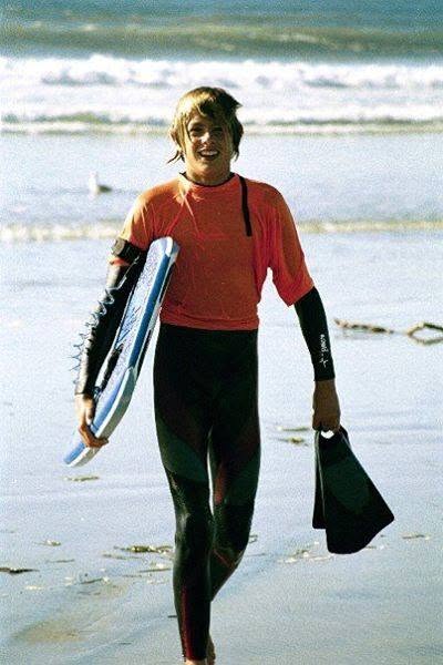 Cody walking out of the surf with bodyboard