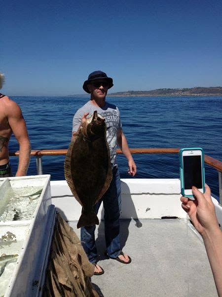 Angler with halibut catch aboard the survey vessel
