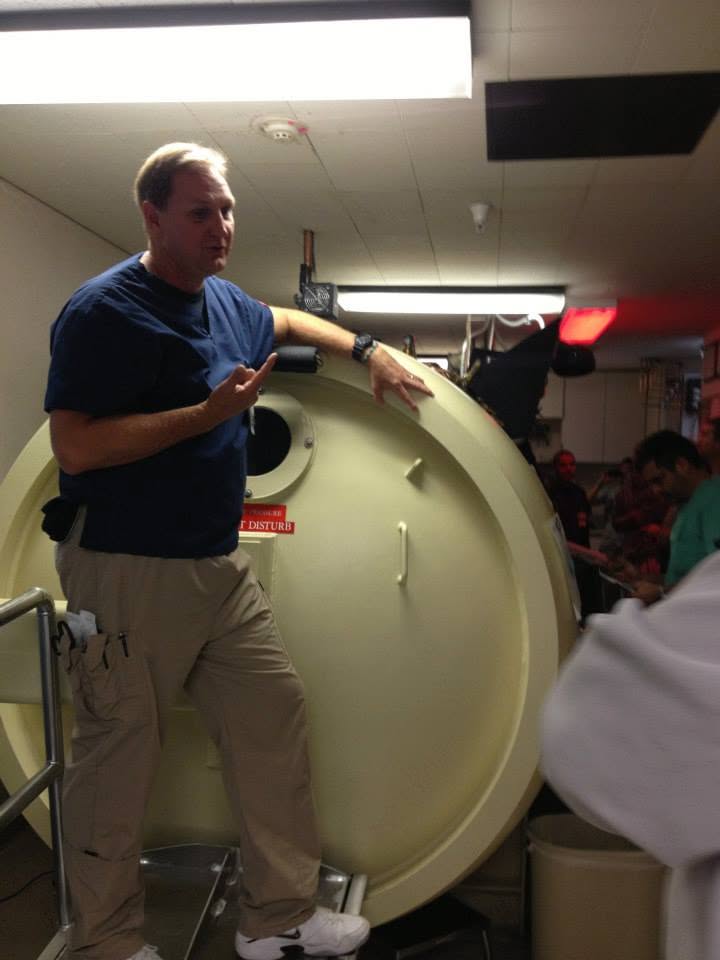 Technician explaining hyperbaric chamber operation