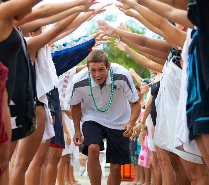 Team welcoming Cody through a tunnel of towels
