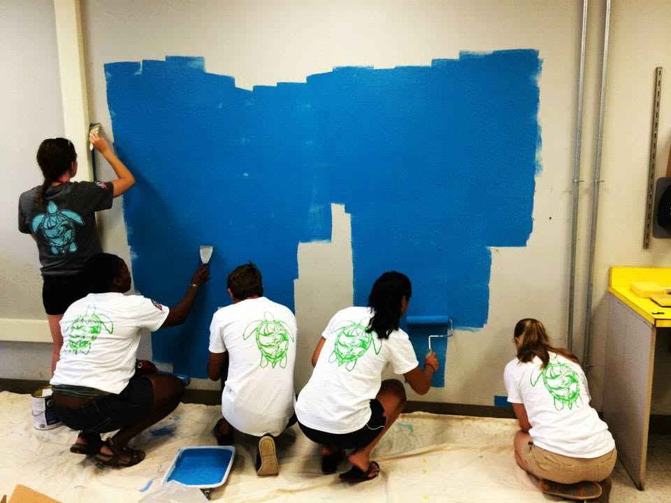 Students painting a sea turtle mural
