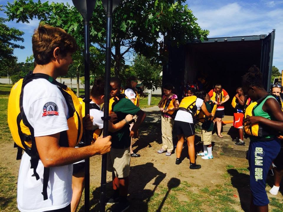 Distributing life jackets to students before a session