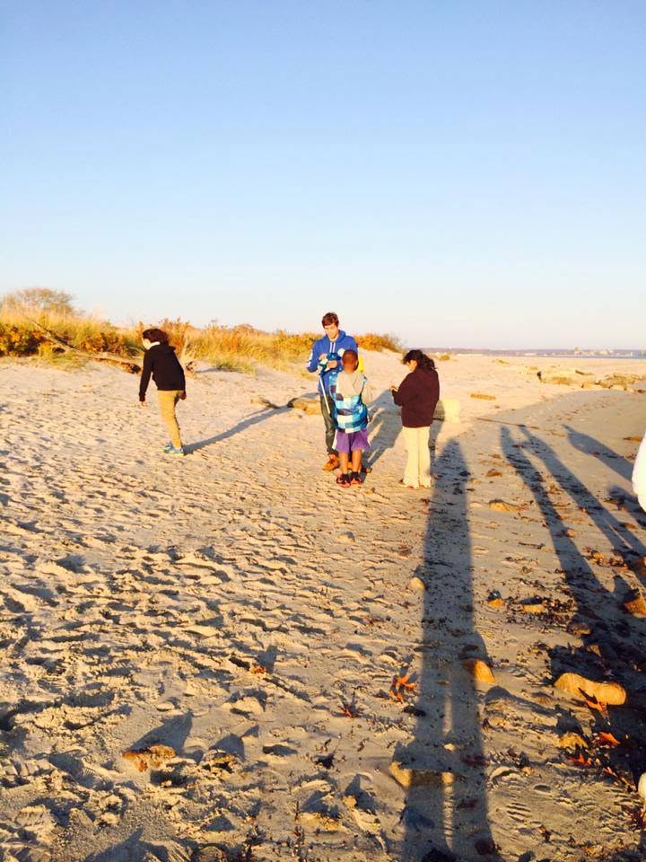 Students beachcombing at dusk, New London, Connecticut
