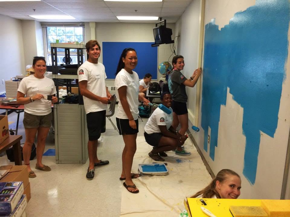 Staff painting the classroom mural during orientation