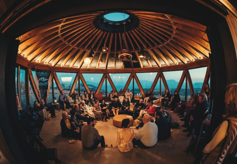Fisheye view of a discussion circle inside a Summit yurt