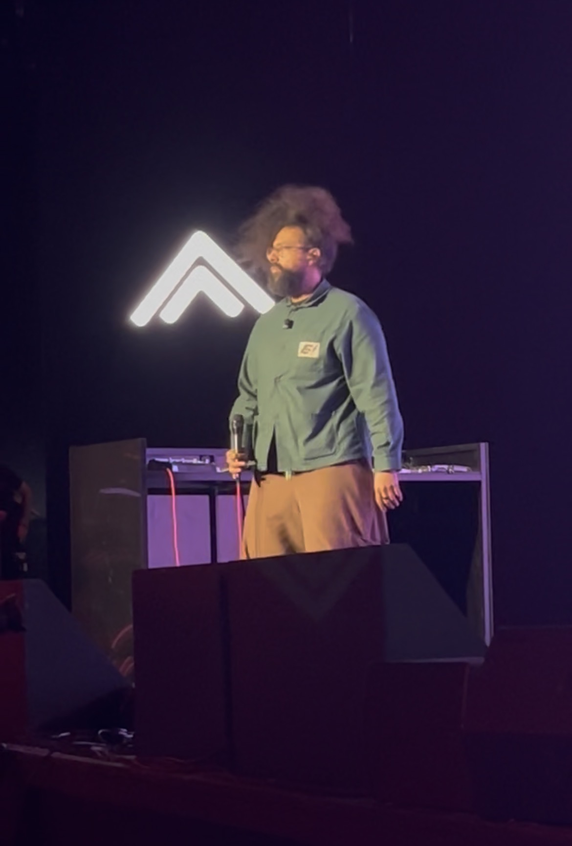 Host on stage beside the Summit mark