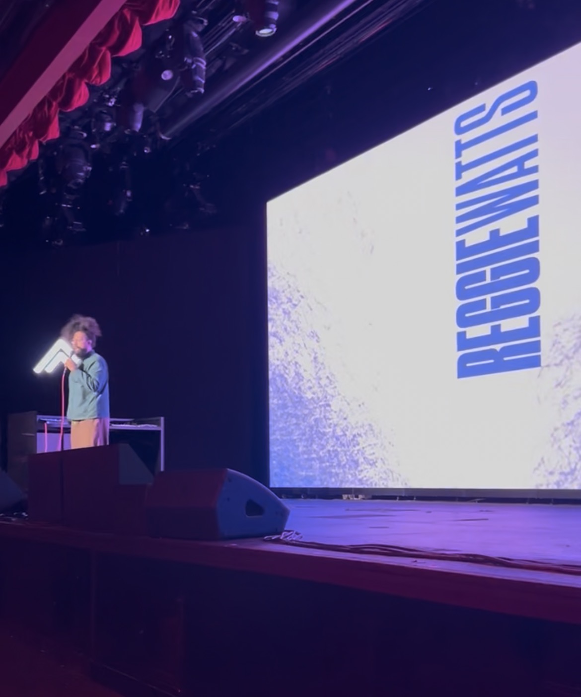 Host introducing a speaker on stage