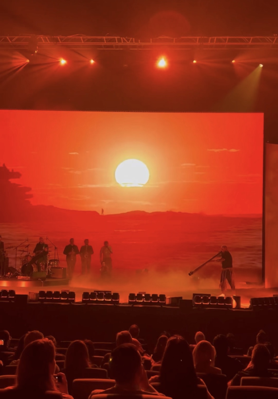 Live performance beneath a sunset backdrop on the main stage
